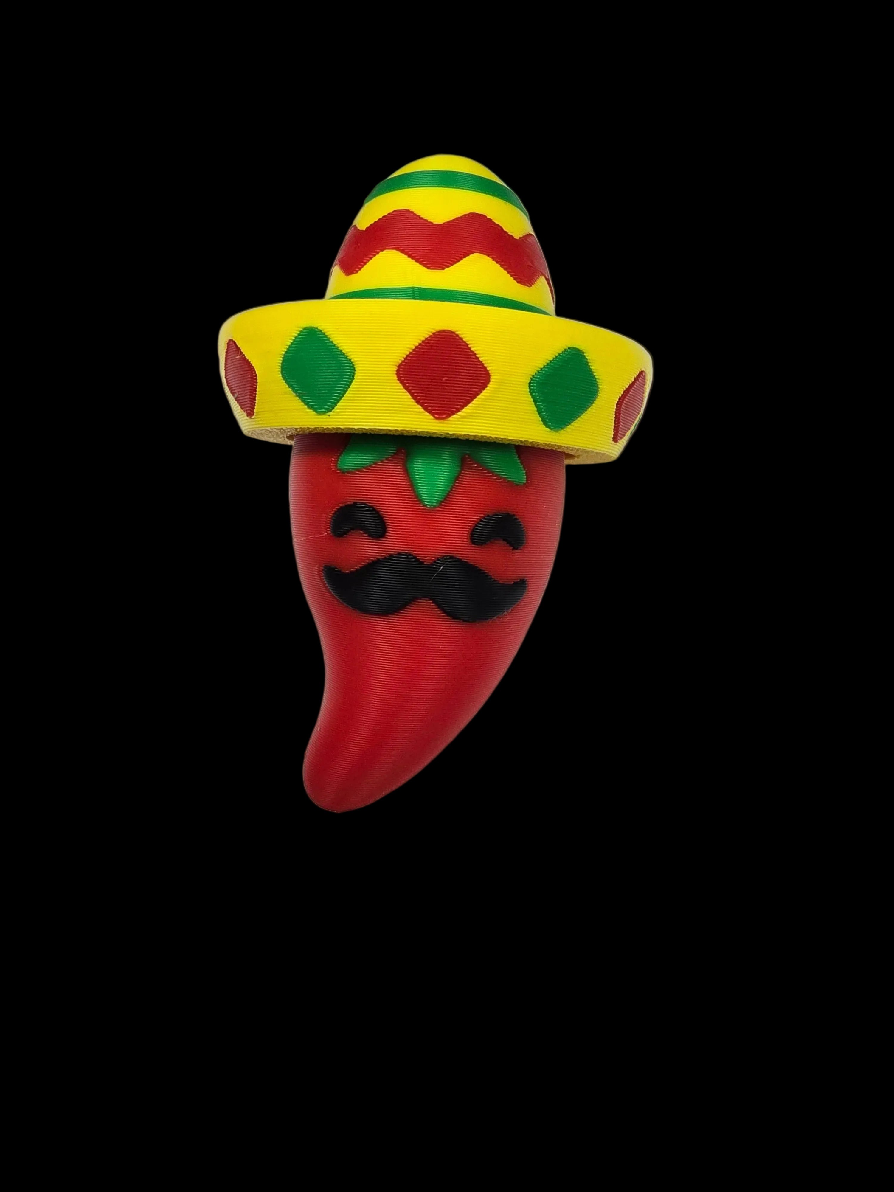 Toy resembling a red pepper with a yellow sombrero on a white background